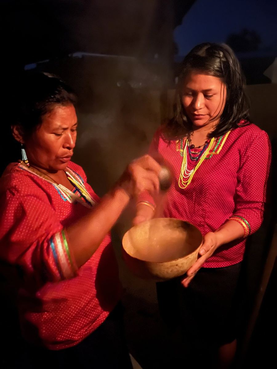 Women preparing traditional guayusa before dawn in the Ecuadorian Amazon