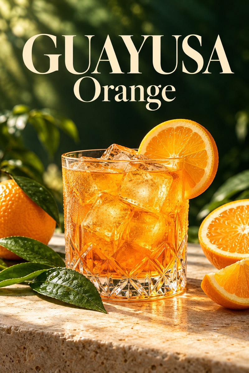 Glass of iced orange guayusa with fresh ingredients and guayusa leaves