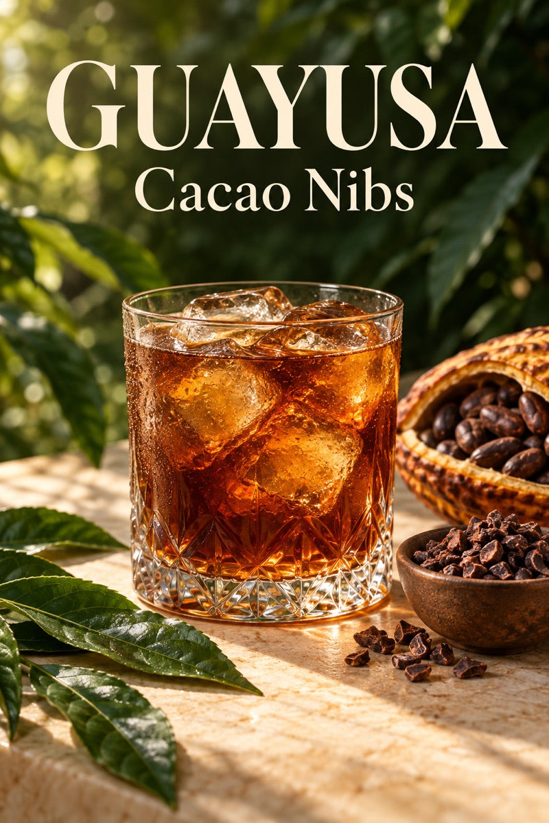 Glass of iced cacao nib guayusa with fresh ingredients and guayusa leaves