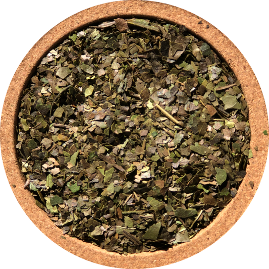 Close-up of Pacha Traditional Guayusa dry loose leaf tea in a round cork bowl